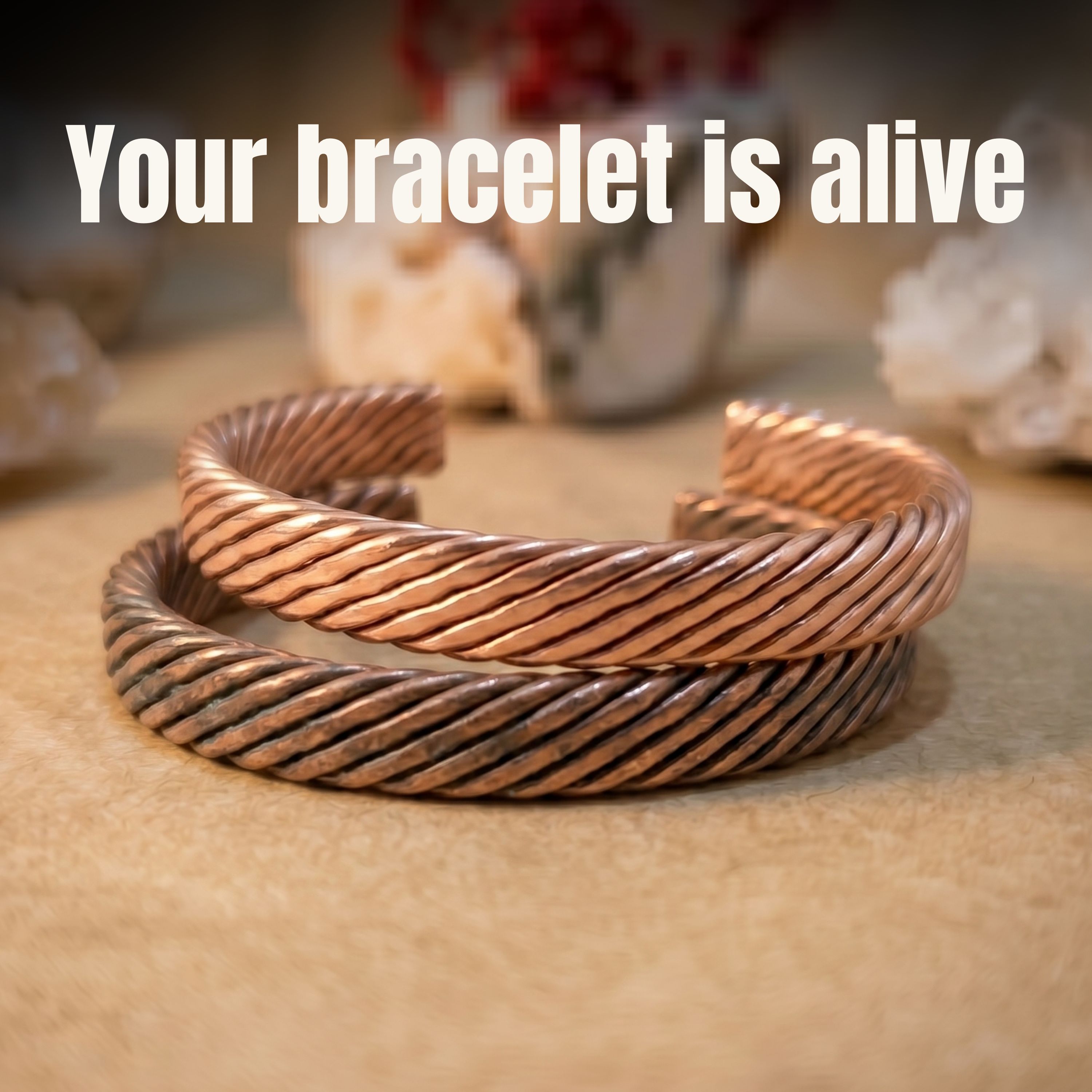 Two stacked woven copper bracelets showcasing different finishes—one dark with a natural patina and one brightly polished—with a bold text overlay reading "Your bracelet is alive